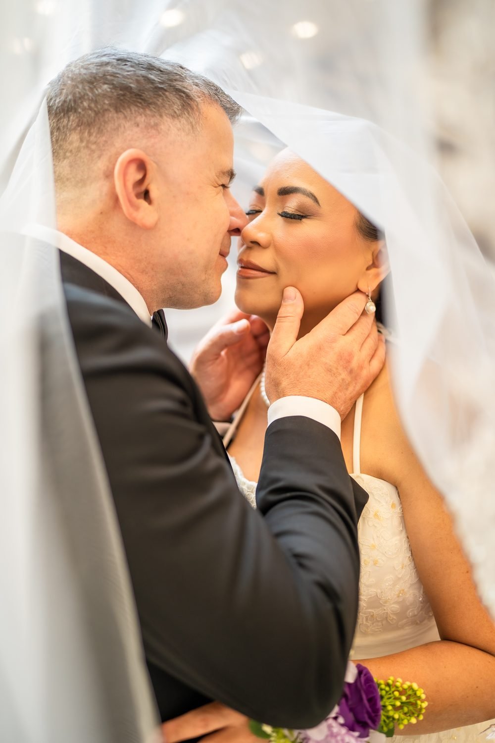 Bride and groom under her veil at a Caboto Club wedding in Windsor