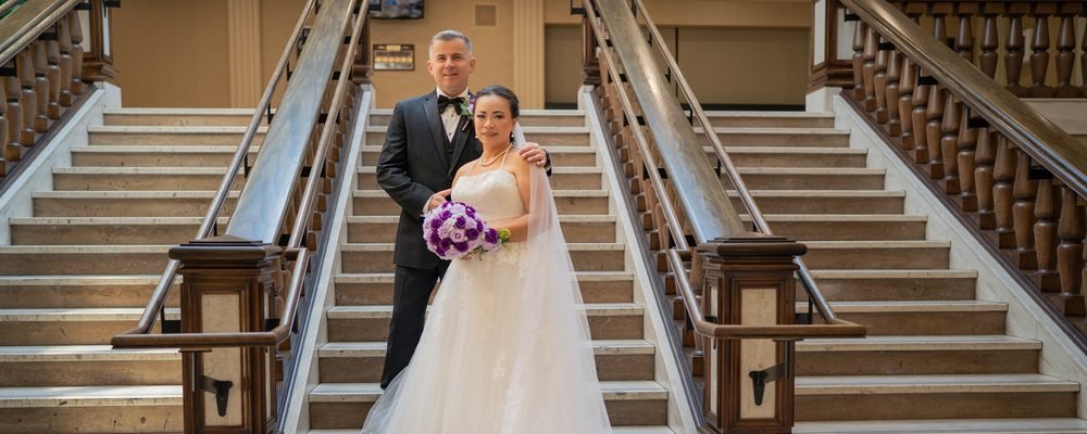 Bride and groom on the grand staircase at the Giovanni Caboto Club in Windsor, Ontario