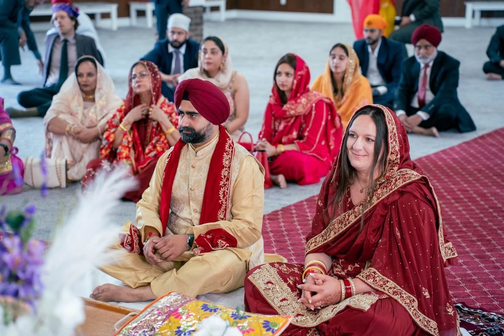 Couple seated during their Sikh wedding ceremony at a Windsor gurdwara