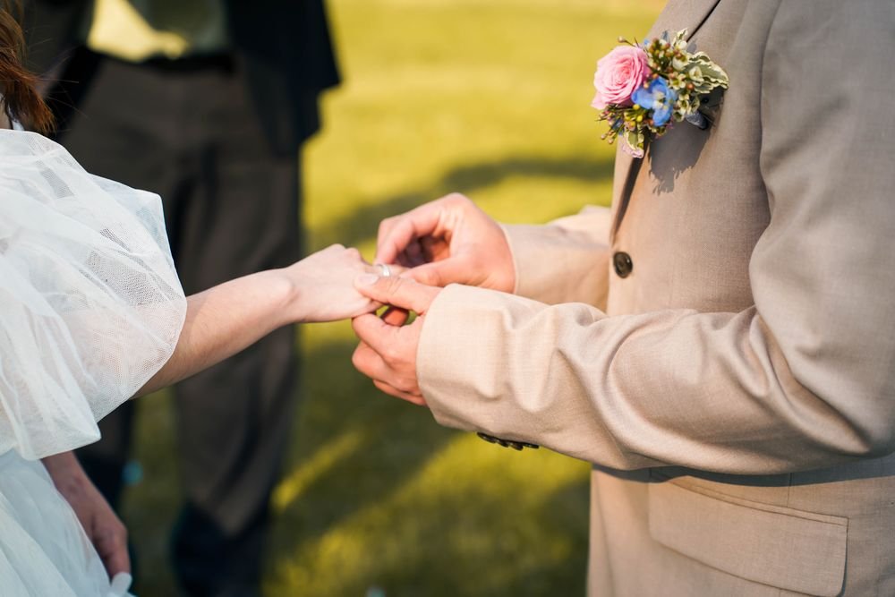 Outdoor wedding ceremony under a flower arch near Windsor Ontario