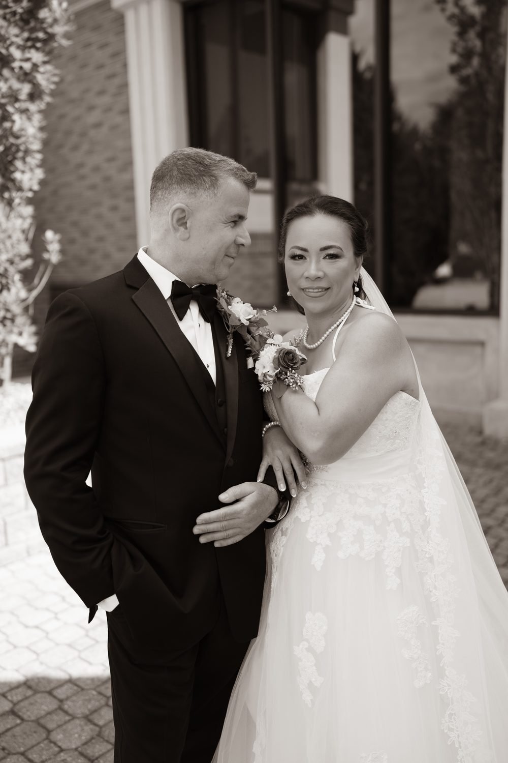 Sepia wedding portrait of a bride and groom outside their Windsor, Ontario venue